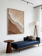 Close-up of a hand-painted 3D textured abstract beach painting featuring heavy wave-like ridges in sand beige and ochre in a gold frame.