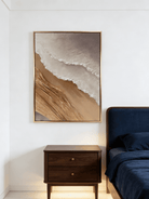 Hand-painted 3D textured abstract coastal painting featuring heavy sculpted ridges in sand beige and ochre in a gold floater frame.