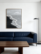 Close-up of a hand-painted 3D textured black sand beach painting with heavy white sculpted seafoam and black waves in a black frame.