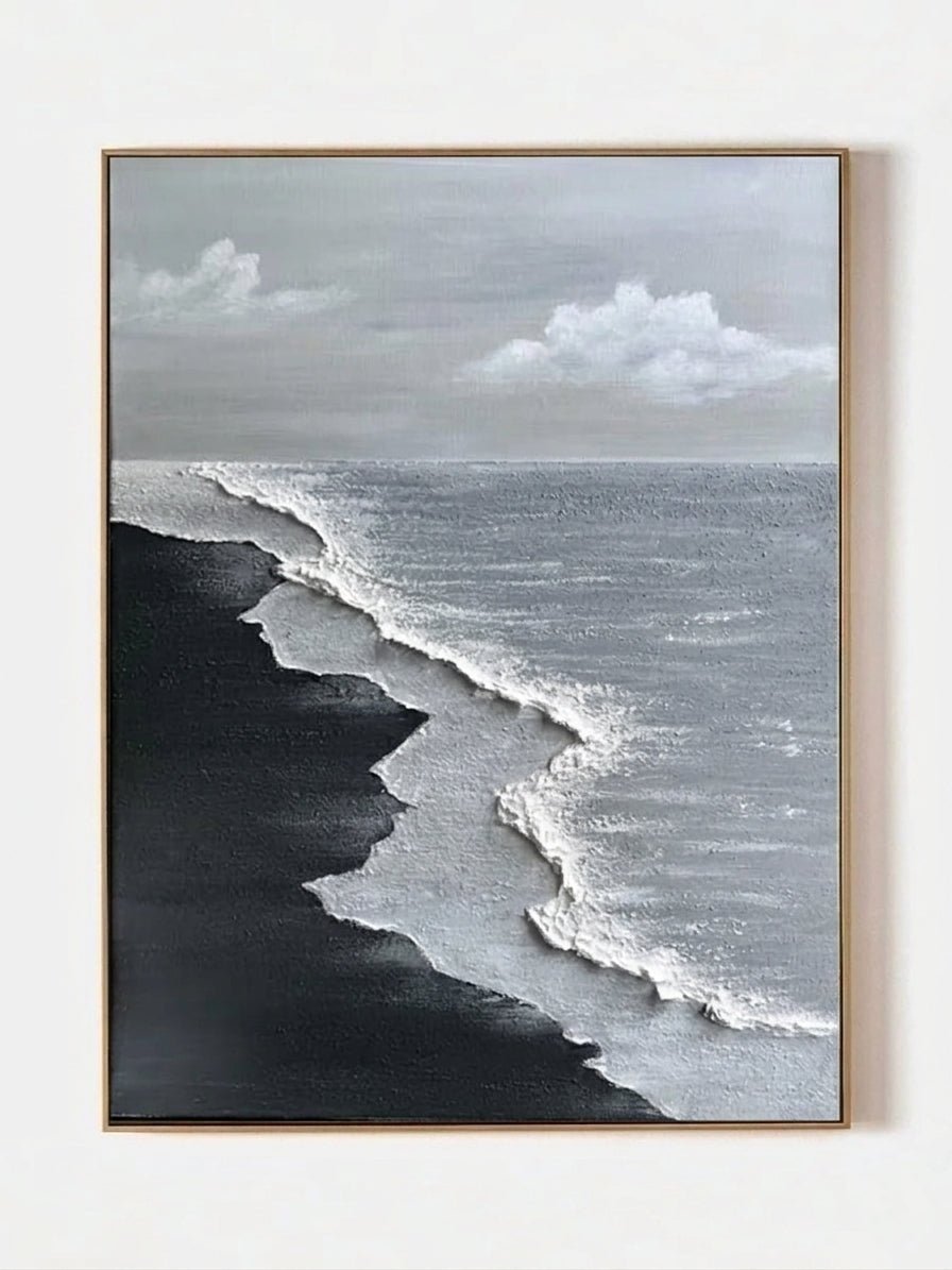 Close-up of a hand-painted 3D textured black sand beach painting with heavy white sculpted seafoam and black waves in a black frame.