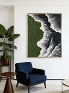 Close-up of a hand-painted 3D textured abstract painting featuring heavy white sculpted foam over moss green and black backgrounds in a gold frame.