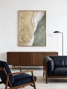 Close-up of a hand-painted 3D textured abstract beach painting with heavy white sculpted foam over sage green and sand backgrounds in a gold frame.