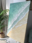 Hand-painted 3D textured beach painting with three distinct layers of thick white sculpted seafoam and mint green water in a gold frame.