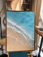 Hand-painted 3D textured beach painting with thick white sculpted seafoam ridges and deep blue water in a gold floater frame.