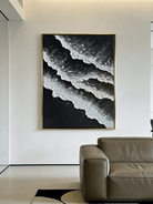Large vertical hand-painted black and white abstract seascape with extra heavy 3D textured waves by Leo Liang in a modern minimalist room.