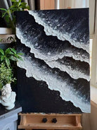Large vertical hand-painted black and white abstract seascape with extra heavy 3D textured waves by Leo Liang in a modern minimalist room.