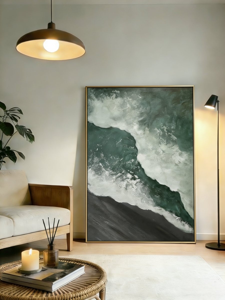 A large vertical 3D textured seascape painting by Leo Liang featuring deep emerald green waves crashing on a black sand shore, displayed in a modern living room.