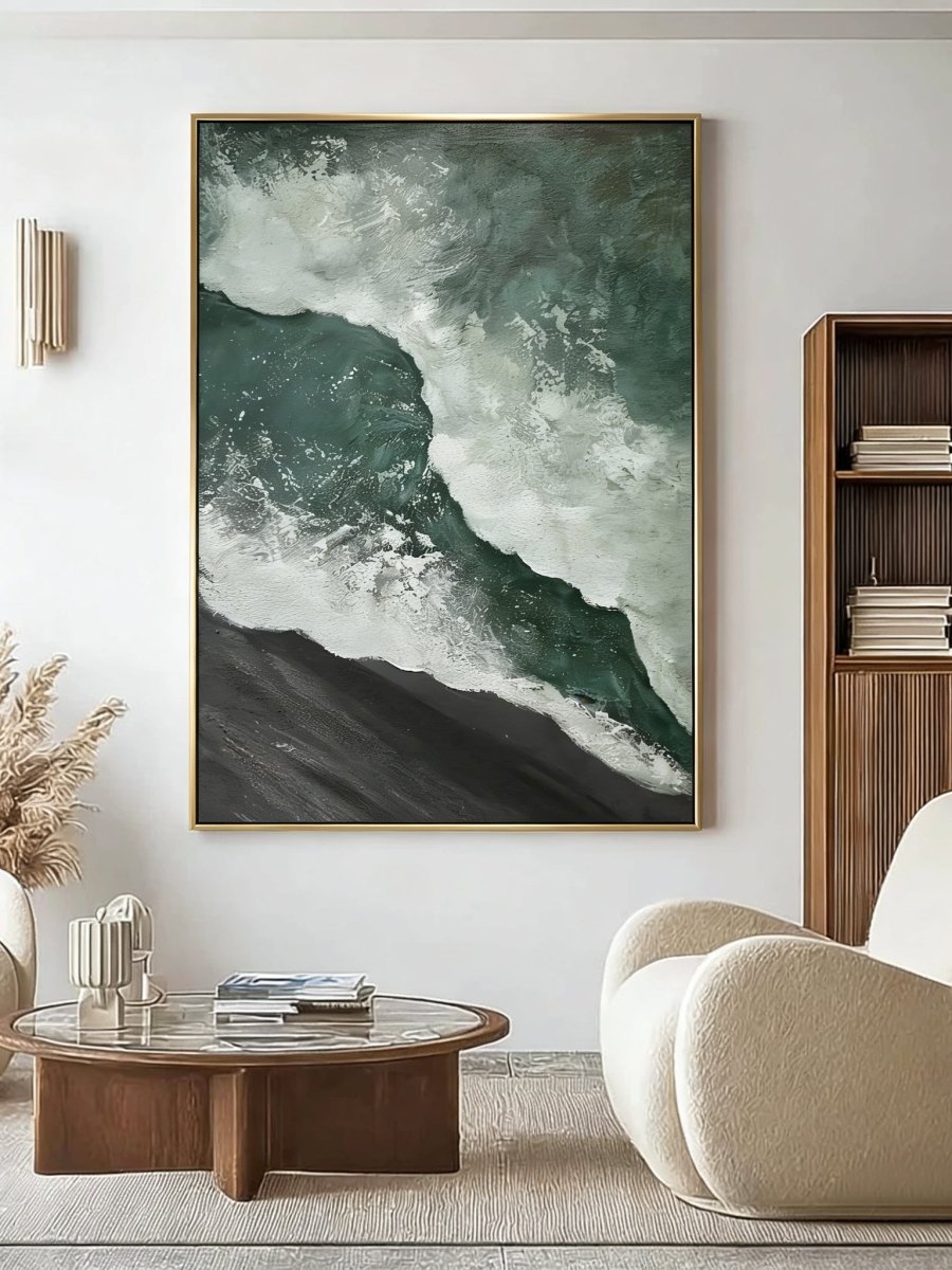 A large vertical 3D textured seascape painting by Leo Liang featuring deep emerald green waves crashing on a black sand shore, displayed in a modern living room.