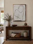 Minimalist black and ivory figure painting above an entryway console in a Japandi foyer