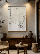 Hand-painted minimalist abstract art; white flowing lines on black canvas and black lines on cream canvas.
