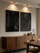 Two-piece hand-painted abstract diptych, white minimalist lines on black textured canvas, luxury wall art for modern living room