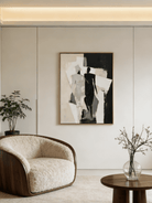 Large hand-painted minimalist abstract canvas art featuring black and white silhouettes and rhythmic lines in a modern home setting.