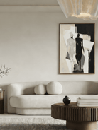 Large hand-painted minimalist abstract canvas art featuring black and white silhouettes and rhythmic lines in a modern home setting.