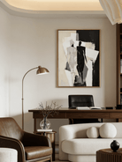 Large hand-painted minimalist abstract canvas art featuring black and white silhouettes and rhythmic lines in a modern home setting.