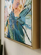 Close-up of 3D heavy textured orange, pink, and white flowers with thick palette knife strokes on a canvas