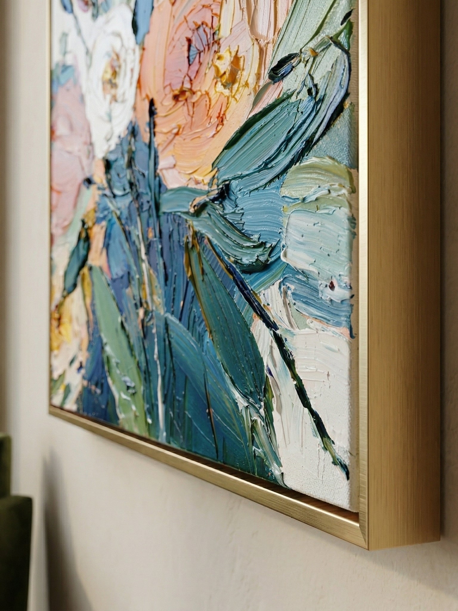 Close-up of 3D heavy textured orange, pink, and white flowers with thick palette knife strokes on a canvas