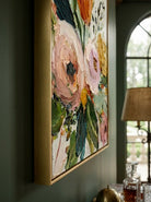 Large vertical 3D textured floral painting with thick impasto pink roses and yellow tulips in a sunlit modern living room.