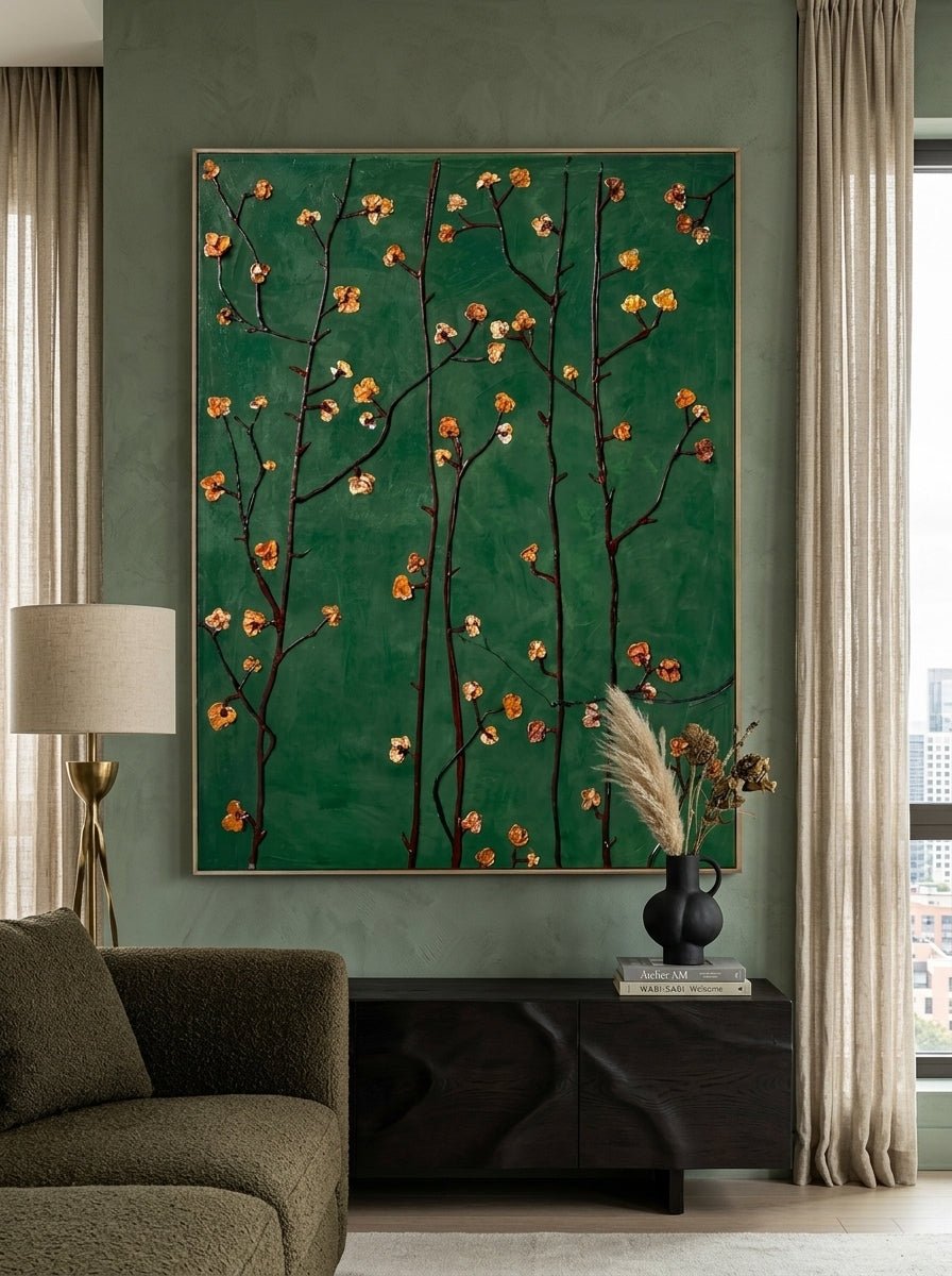 Close-up of heavy textured hand-painted floral oil painting with emerald green background and amber flower blossoms on dark branches.