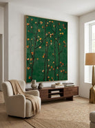 Close-up of heavy textured hand-painted floral oil painting with emerald green background and amber flower blossoms on dark branches.