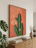 Large 100% hand-painted modern boho Southwestern cactus canvas painting with heavy 3D palette knife textured peach pink flower petals over a warm terracotta background by Luna Xiao for living room decor.