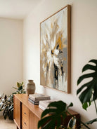 Large hand-painted modern abstract canvas painting with 3D heavy palette knife texture featuring a gold and white floral burst by Luna Xiao for luxury living room decor.