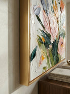Large square 3D textured floral painting showing heavy impasto yellow and peach flowers on a white background in a modern bright living room.