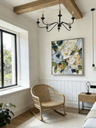 Large square 3D textured floral painting showing heavy impasto green and white flowers in a modern bright living room.