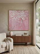 Close-up of large 3D textured abstract painting showing heavy white and taupe impasto ridges on canvas in a luxury living room.