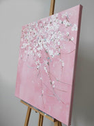 Close-up of large 3D textured abstract painting showing heavy white and taupe impasto ridges on canvas in a luxury living room.