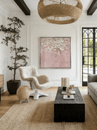 Close-up of large 3D textured abstract painting showing heavy white and taupe impasto ridges on canvas in a luxury living room.