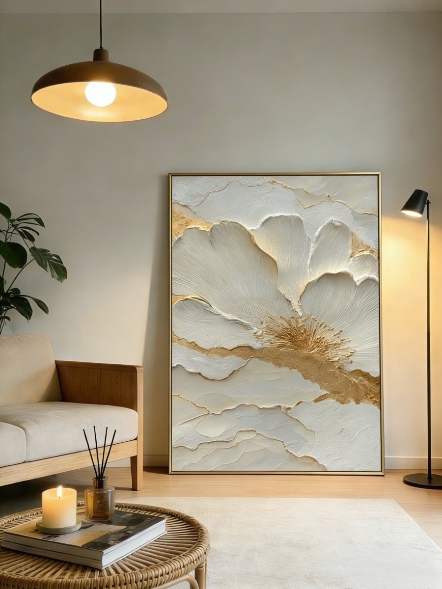 Close-up view of heavy 3D sculptural white flower petals with gold foil edges on canvas, hand-painted by Luna Xiao in a minimalist living room setting.