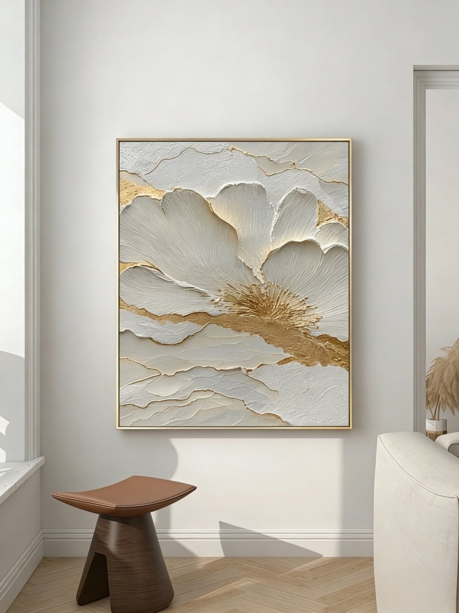Close-up view of heavy 3D sculptural white flower petals with gold foil edges on canvas, hand-painted by Luna Xiao in a minimalist living room setting.