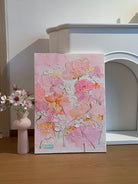 Hand painted pink floral canvas styled beside a white fireplace