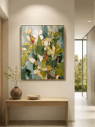 Vertical textured botanical wall art displayed above an entryway console in an organic modern interior