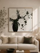 White hydrangea painting displayed above a neutral sofa in an organic modern living room