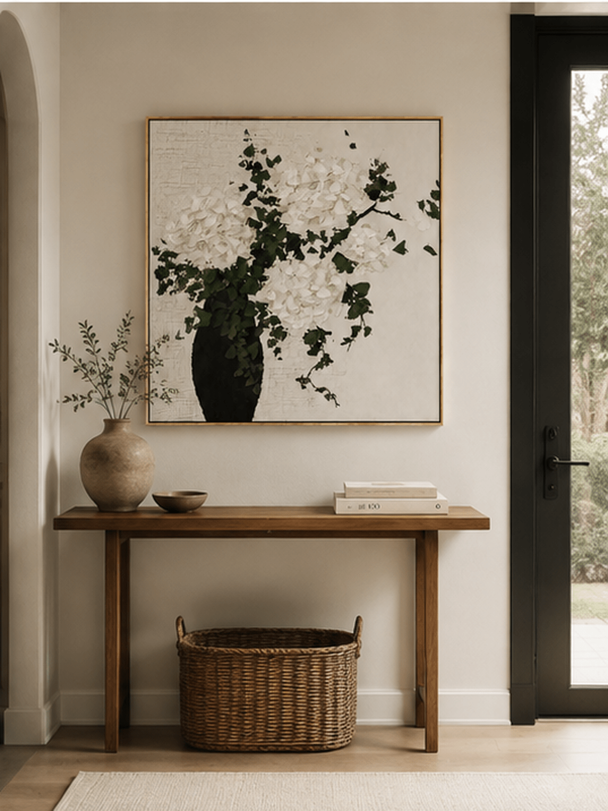 White hydrangea vase painting displayed above a wood console in a modern neutral entryway