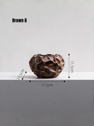 surrealist walking mushroom sculpture in bronze brown resin, paired with textured geometric vases on a bookshelf for modern home decor.