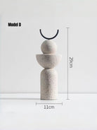 abstract geometric resin sculpture with sandstone texture, minimalist cream and black totem for modern home office shelf decor.