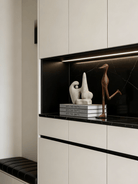 abstract biomorphic resin sculptures, sandstone texture stone art and wood finish running bird figurine on a bookshelf.