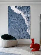 Textured abstract seascape artwork displayed in contemporary living room, showcasing coastal wall decor in modern interior