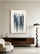 A hand-painted minimalist abstract painting of six tall figures in blue and grey on a white background with gold leaf accents