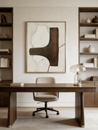 Hand-painted organic modern abstract painting featuring stone-textured background, brown and black shapes in a gold floater frame.