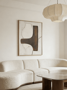 Hand-painted organic modern abstract painting featuring stone-textured background, brown and black shapes in a gold floater frame.