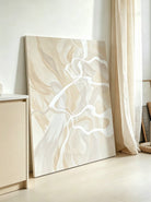 Large 100% hand-painted modern organic abstract canvas painting with fluid ivory white lines over a warm beige and oatmeal background by Seraphina Rose for bedroom wall decor.