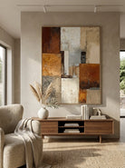 Close-up of 3D heavy textured abstract oil painting in burnt orange, ochre, and grey by Seraphina Rose for modern living room decor.