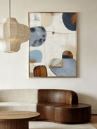 Hand-painted modern organic abstract painting featuring blue and brown geometric shapes with thick texture in a gold floater frame.