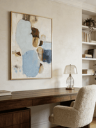 Hand-painted modern organic abstract painting featuring blue and brown stone-like shapes with heavy impasto texture in a gold frame.