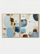 Large 2-piece hand-painted abstract diptych with organic blue and terracotta shapes and heavy texture by Seraphina Rose in a modern coastal living room.
