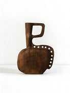 hand-carved modern primitive wood totem sculpture with dark walnut finish and hole details, large abstract wooden art for living room decor.