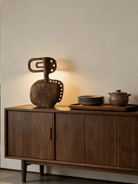 hand-carved modern primitive wood totem sculpture with dark walnut finish and hole details, large abstract wooden art for living room decor.